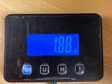 a digital clock on a table with a charger