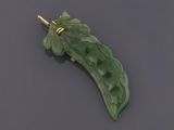 une image représentant une broche en forme de feuille de jade vert posée sur une surface noire