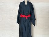 an image of a black robe on a mannequin stand