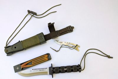 several different types of knives are laid out on a white surface