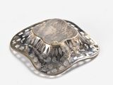 silver plated brooch with a flower design on a white background