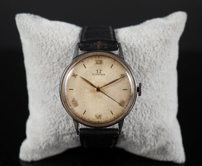a close up of a wrist watch on a pillow