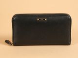 a black leather wallet with gold hardware and zipper closure