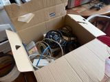 a cardboard box filled with wires and wires on the floor