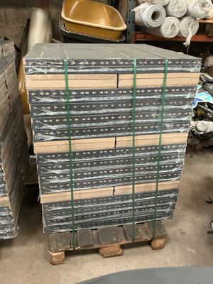 many stacks of metal items stacked on pallets in a warehouse