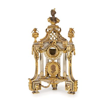 a gold and white clock with a bird on top of it