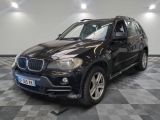 a picture of a black bmw suv parked in a garage