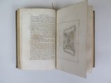 an open book with a drawing on it on a table