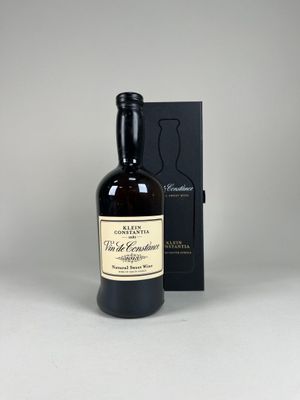 an empty bottle of whisky sitting next to a black box