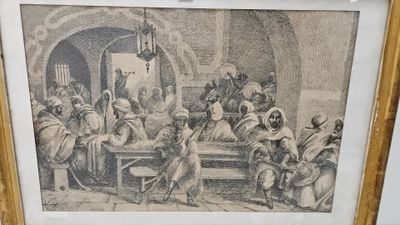 une vieille photo d'un groupe de personnes assises autour d'une table