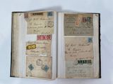 an open book with a bunch of stamps on it sitting on a table