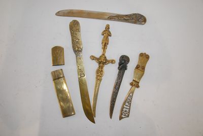 five different types of knives on a white surface