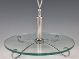 a glass cake stand with a metal handle on it