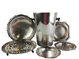 a lot of silver items that are sitting on a table