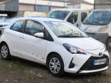 a white toyota yaris parked in a parking lot