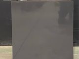 an image of a black refrigerator sitting on the sidewalk