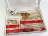 silverware in a silver case with red handles and spoons