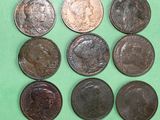 six different types of coins are shown on a green surface