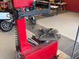 a red machine that is sitting on a pallet in a room