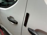 a close up of a car door handle with a sticker on it