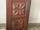 a small wooden cabinet with a door on the floor