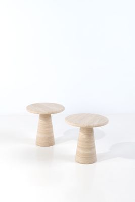 two small wooden stools sitting on top of a white surface
