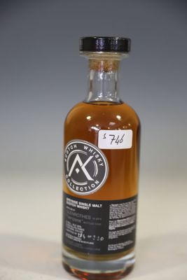 a bottle of whisky sitting on top of a white table