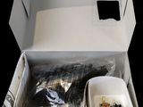 a white box with a cup and some food in it