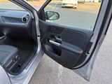 a door open of a car with the driver ' s seat down
