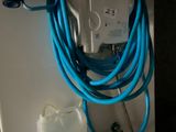 a blue hose attached to a wall with a water hose attached to it