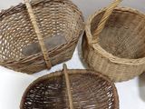 three wicker baskets sitting on top of a white table