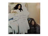 an old photo of a woman laying in a bed with a sign on it
