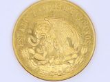 a gold coin with a picture of an elephant on it