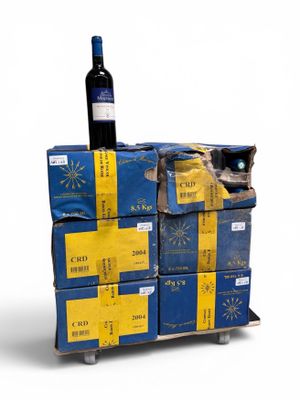 a wine bottle sitting on top of a stack of boxes