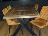 a wooden table with four chairs around it in a room