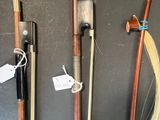 four different types of wooden canes are lined up on a table