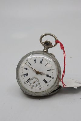 a silver pocket watch with roman numerals on it