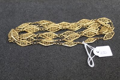 a close up of a gold chain with a tag on it