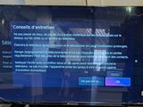 a flat screen tv sitting on top of a wooden table