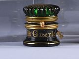 a glass display case with a black and gold container