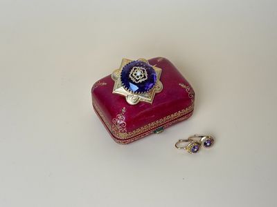 a small red box with a blue flower on it