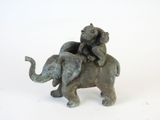 a statue of an elephant and a cat sitting on top of each other