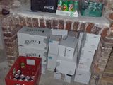 a brick wall with boxes and cans of beer on it