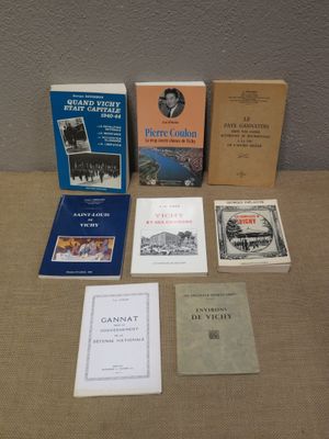 several books are sitting on a table next to each other