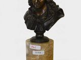 bronze bust of a man with curly hair on a marble base