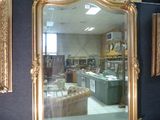 a large gold mirror in the middle of a room