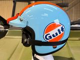 a blue and orange helmet sitting on top of a green table