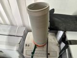 a white cup sitting on top of a stack of electronic equipment