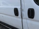 a white van with black trims parked in a parking lot