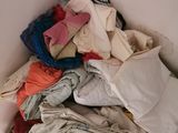 a pile of clothes sitting on the floor in a room
